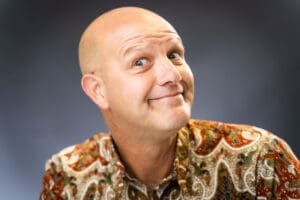Smiling bald man in patterned shirt